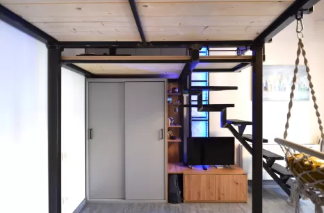 Camera realizzata con soppalco e scala in ferro grezzo